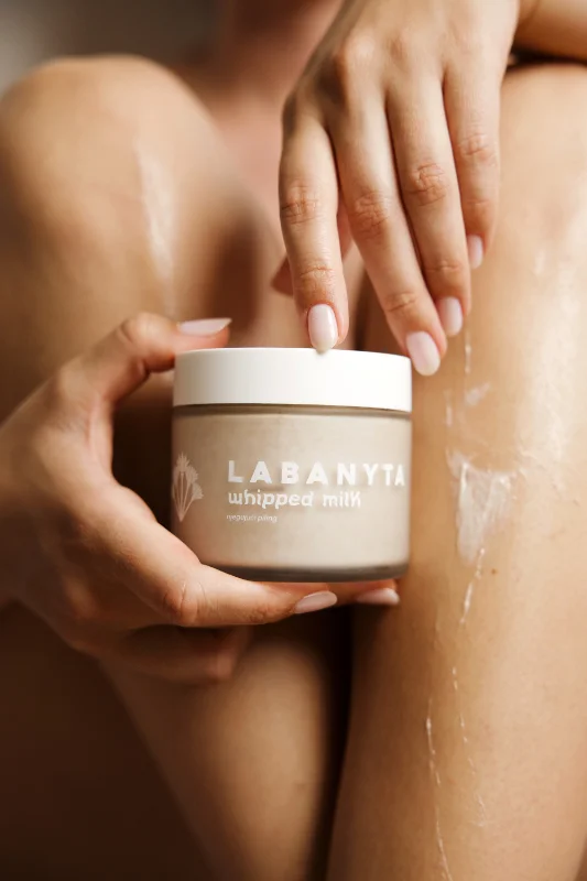 Labanyta Whipped MIlk kremu drži u rukama ženska osoba ispred nogu